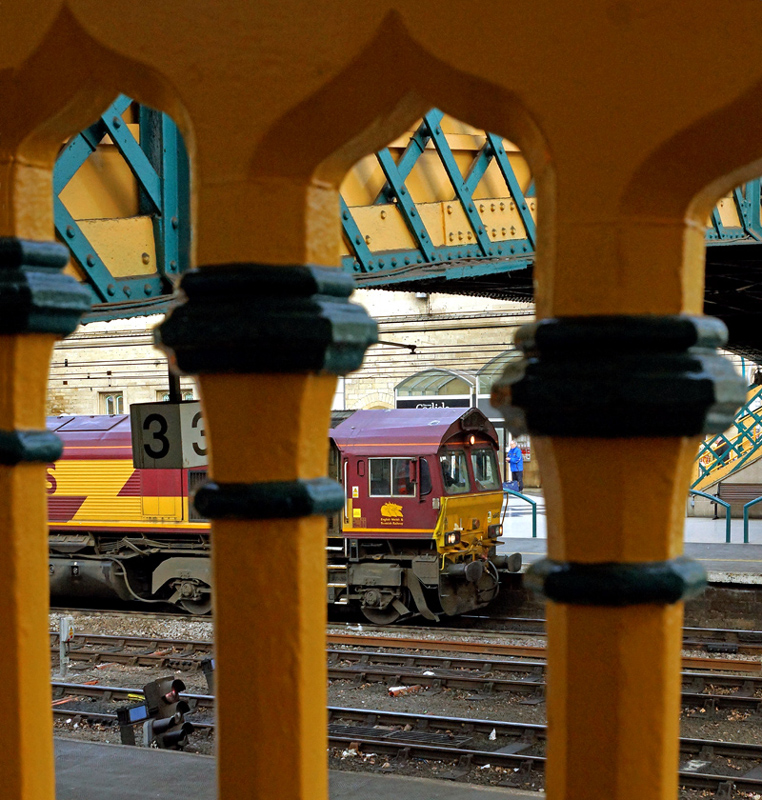 An oriental viewpoint
DB Schenker 66145 heading 6K05 Carlisle Yard to Crewe Basford Hall Yard seen through the recently restored ogee banisters at Carlisle station platform 3 ramp.
