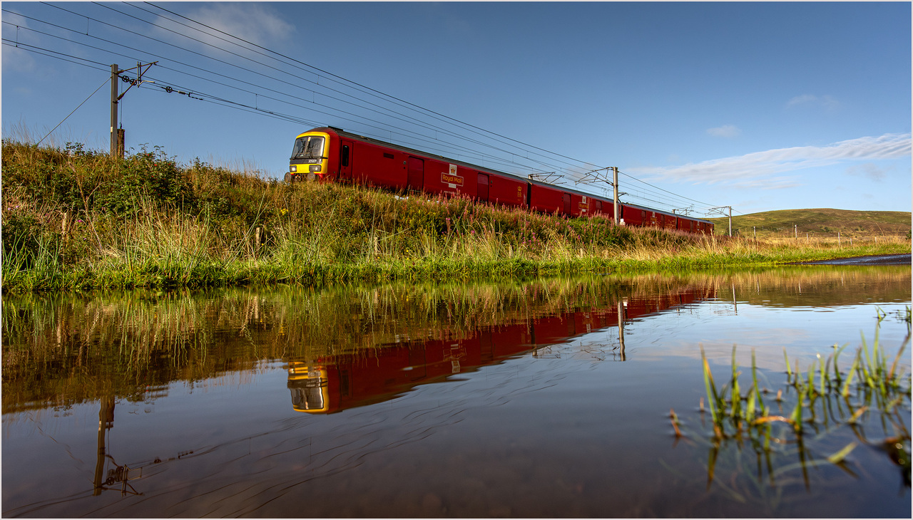 Endings 1
September 2024 saw numerous endings on the British national rail network and certainly the 194 year partnership between the railways and Royal Mail a shock for many. With 17 days remaining 325009 is captured working 1M36 08:34 Shieldmuir to Daventry reflected in the flooded roadway between Crawford and Abington. The last mail trains ran on 20th September with 009 being part of the final service to run out of the Willesden Princess Royal Distribution Centre.
