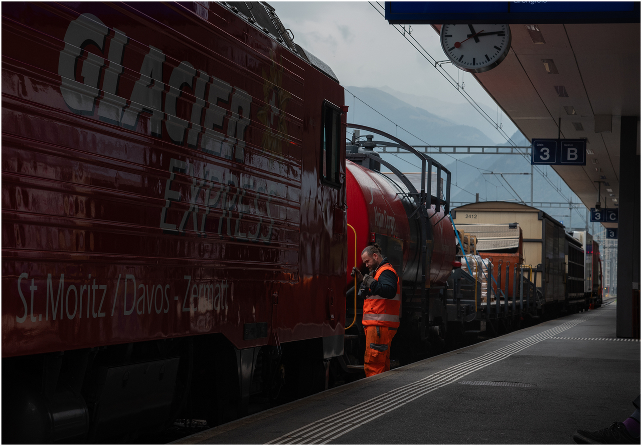 Mixed Freight Preparation
A shunter on the Matterhorn Gotthard Bahn is coupling up loco 105 at Visp to a mixed freight for Zermatt.
