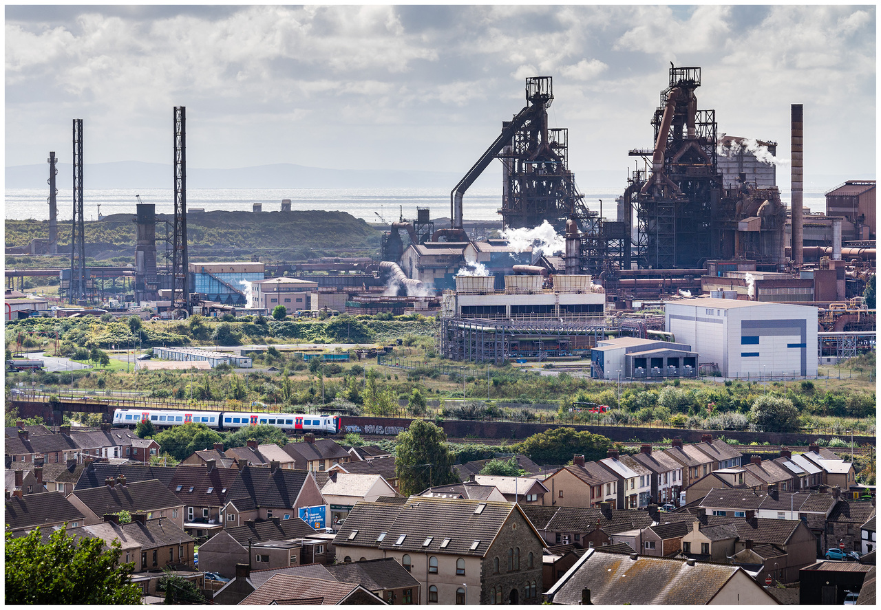 Steel Town
The remaining working blast furnace at Port Talbot steel works shut down at the end of September 2024.
Earlier that month Class 197 no.197051 passes the backdrop of the blast furnaces with the 1W60 Milford Haven to Manchester Piccadilly.
